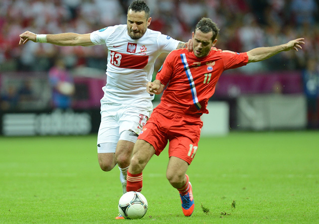 A lengyel és az orosz válogatott játékosai küzdenek a két csapat mérkőzésén az Európa-bajnokságon 2012-ben.